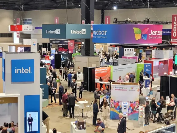 Educause 2023 Conference attendees gathered in a conference hall exploring various IT and higher ed booths