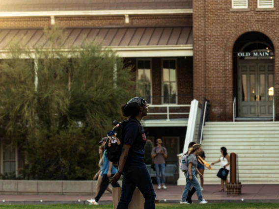 Students walking on campus, in front of Old Main 