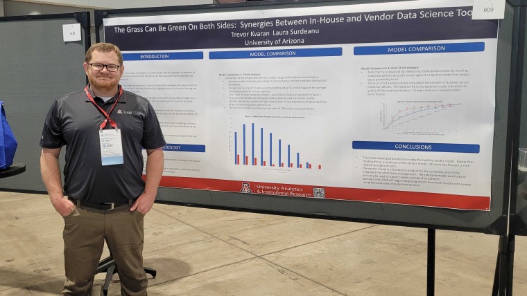 Data Scientist Trevor Kvaran standing in front of his poster at Educause 2023 Annual Conference