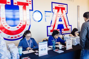 Attendees checking in at the registration tables of the Data Summit in the SUMC Diamond Atrium