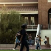 Students walking on campus, in front of Old Main 