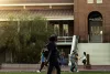 Students walking on campus, in front of Old Main 